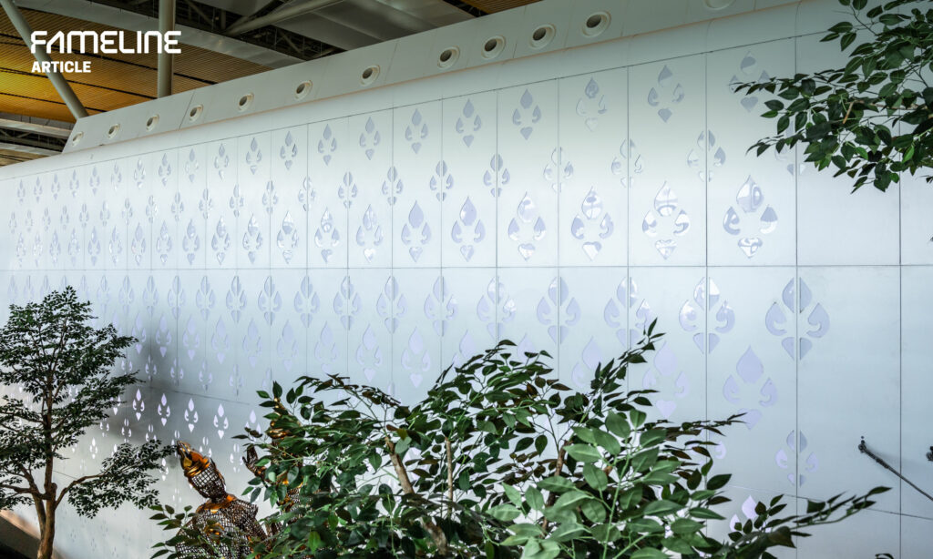 Decorative aluminum wall panel with intricate leaf patterns creating a serene botanical theme, featured in a FAMELINE ARTICLE, reflecting innovative design in metalwork that complements green indoor spaces for sustainable and aesthetic architecture.